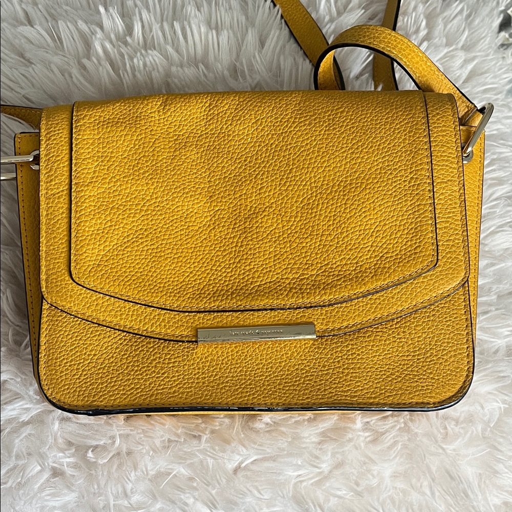 Kate Spade New York mustard yellow crossbody purse.